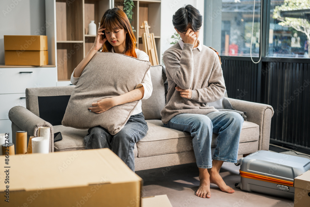 A man and a woman sit on a sofa, visibly upset and arguing, reflecting marital conflict and relationship stress at home. Their discussion shows signs of disagreement and emotional strain. A man and a woman sit on a sofa, visibly upset and arguing, reflecting marital conflict and relationship stress at home. Their discussion shows signs of disagreement and emotional strain.