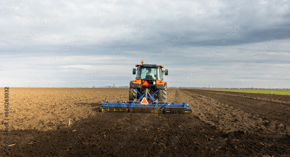 Tractor preparing the land for a new crop planting Tractor preparing the land for a new crop planting