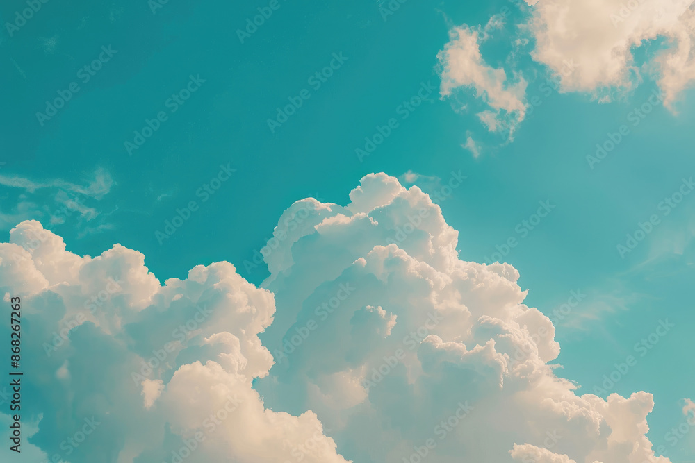 Naklejka premium Creamy white clouds drifting in a vibrant blue sky