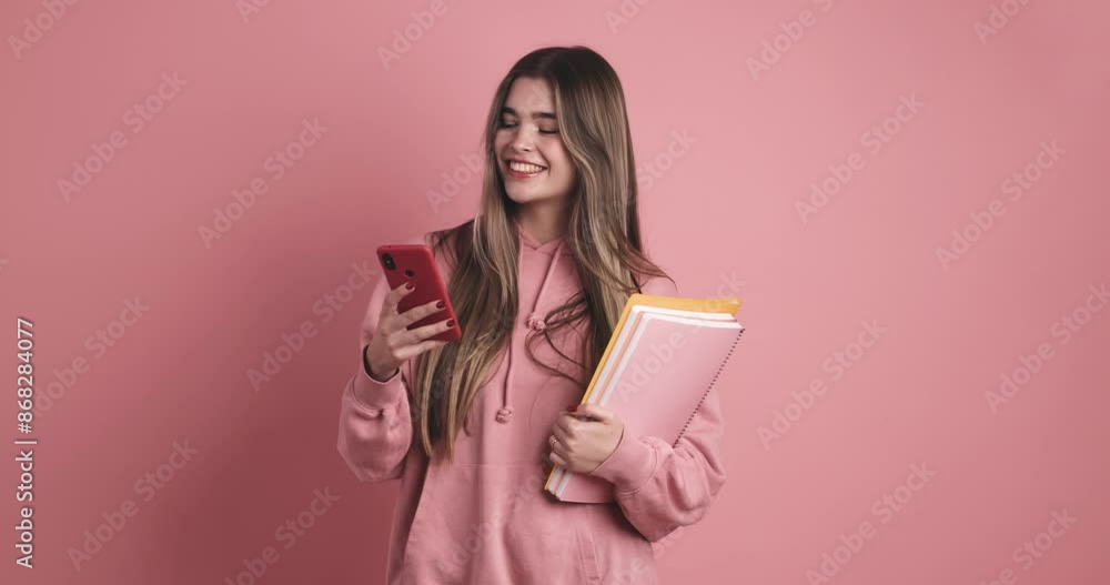 Young woman student standing with books and smartphone Young woman student standing with books and smartphone