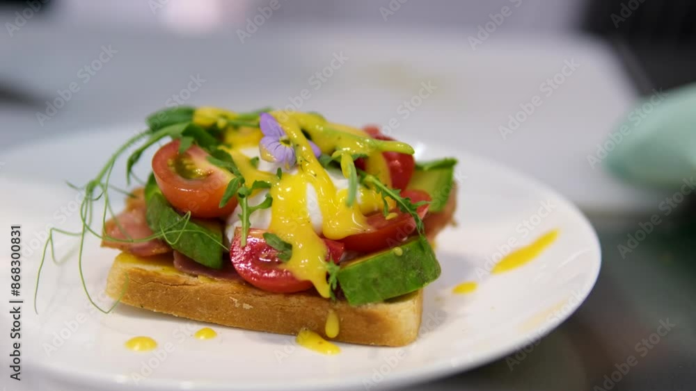 Poached eggs Benedict. Toast with poached egg and bacon close up. Cutting poached egg with runny egg yolk over toast . Healthy breakfast or lunch food Poached eggs Benedict. Toast with poached egg and bacon close up. Cutting poached egg with runny egg yolk over toast . Healthy breakfast or lunch food
