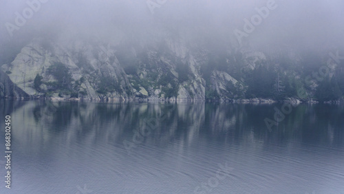 Morning fog in the Cavallers reservoir (Boí Valley, Aigüestortes i Estany de Sant Maurici National Park, Catalonia, Spain, Pyrenees)