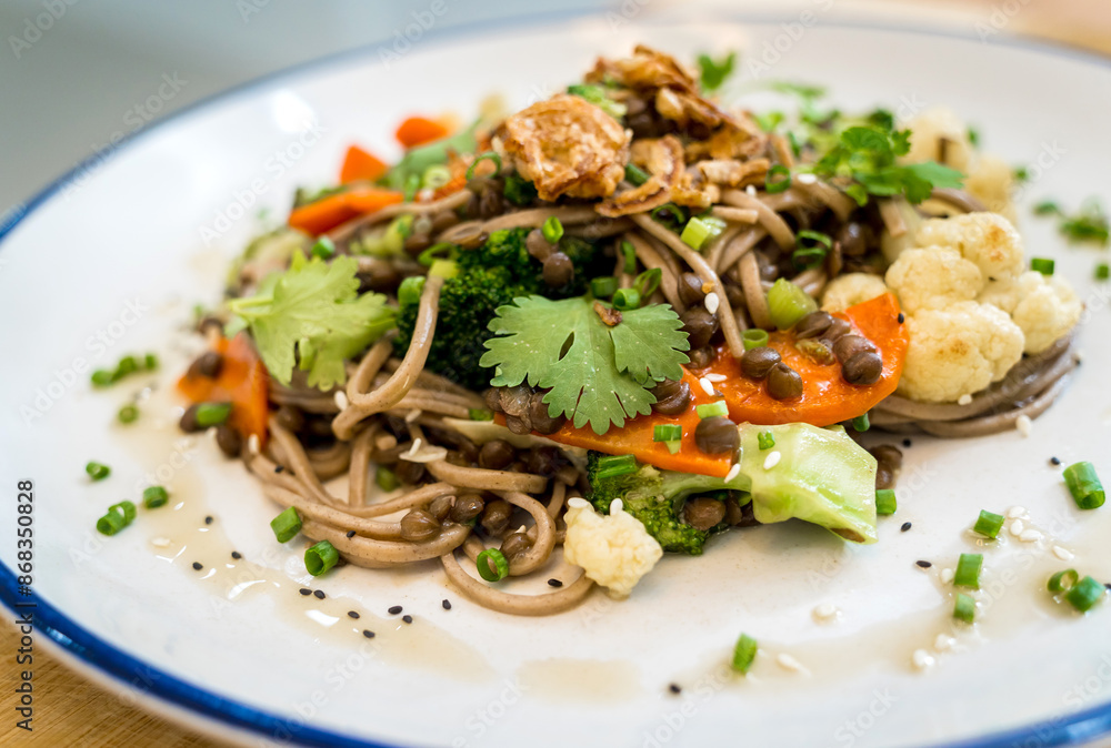 Japanese buckwheat pasta with lentils and vegetables in a bowl Japanese buckwheat pasta with lentils and vegetables in a bowl
