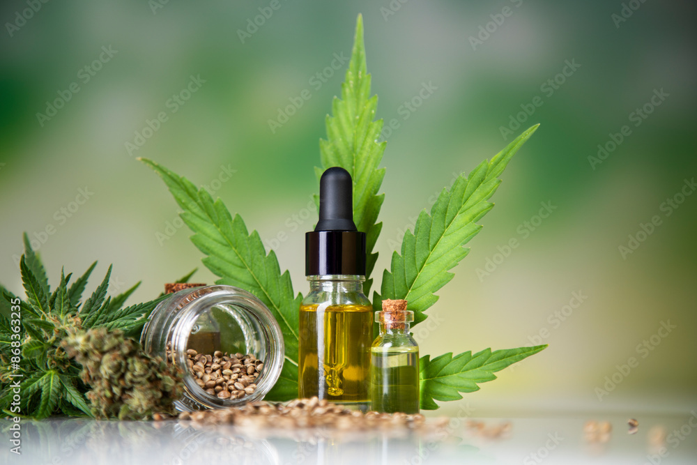 Fototapeta premium Hemp oil bottle with hemp leaf and cannabis leaf, marijuana