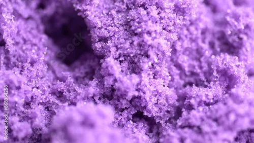 Purple kinetic sand background, closeup. Macro shot of kinetic sand texture.