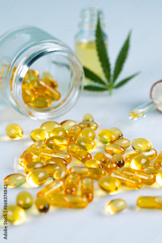 Marijuana oil, leaf and capsules on a white background Marijuana oil, leaf and capsules on a white background