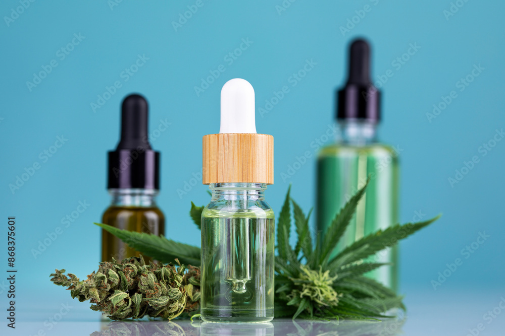 Bottles of cbd oil, marijuana and hemp leaves