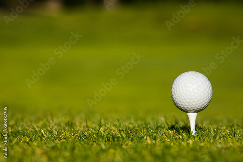 Golf ball and clubs in golf field