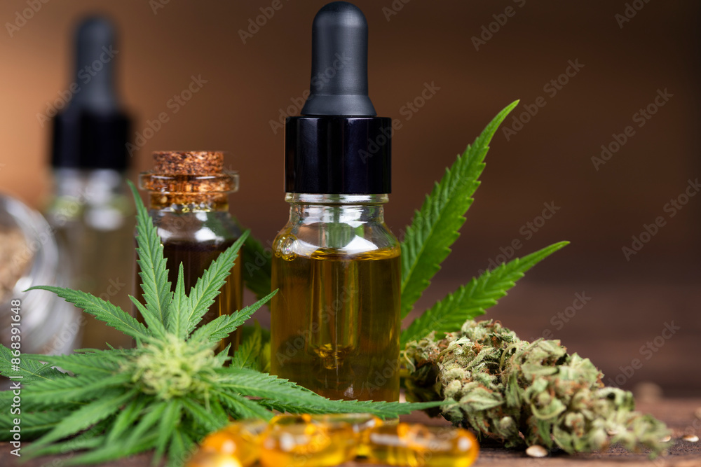 Cbd hemp oil in bottle and marijuana leaves Cbd hemp oil in bottle and marijuana leaves