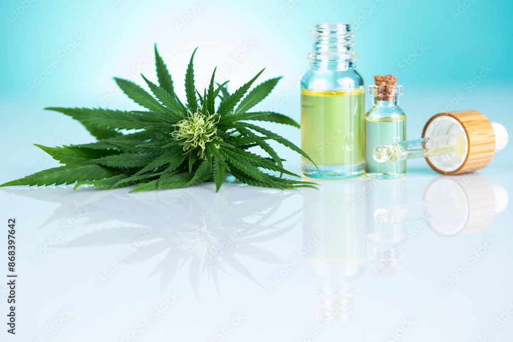 Fototapeta premium Bottles of cbd oil, marijuana and hemp leaves