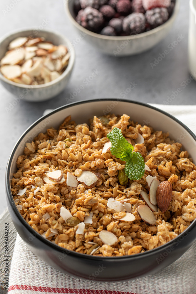 Crispy homemade granola with sliced almonds in a bowl. Healthy food Crispy homemade granola with sliced almonds in a bowl. Healthy food