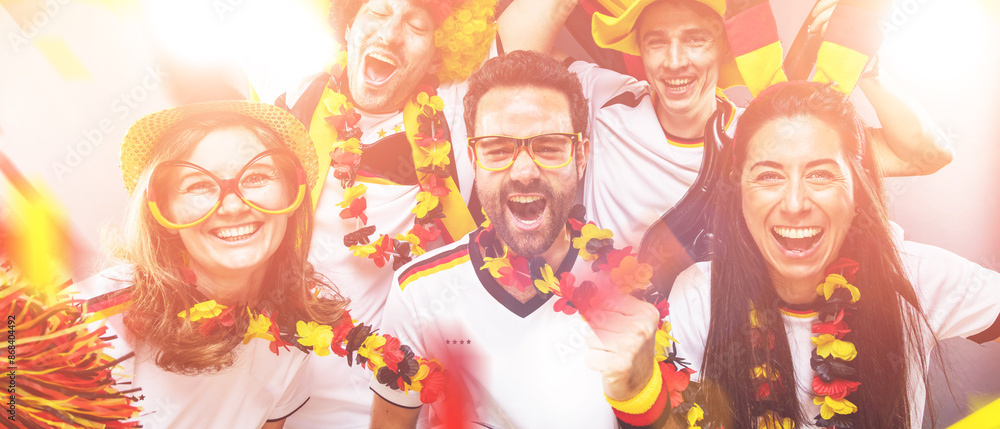 Group of enthusiastic German soccer fans celebrating the victory Group of enthusiastic German soccer fans celebrating the victory