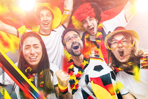 Group of enthusiastic German soccer fans celebrating the victory