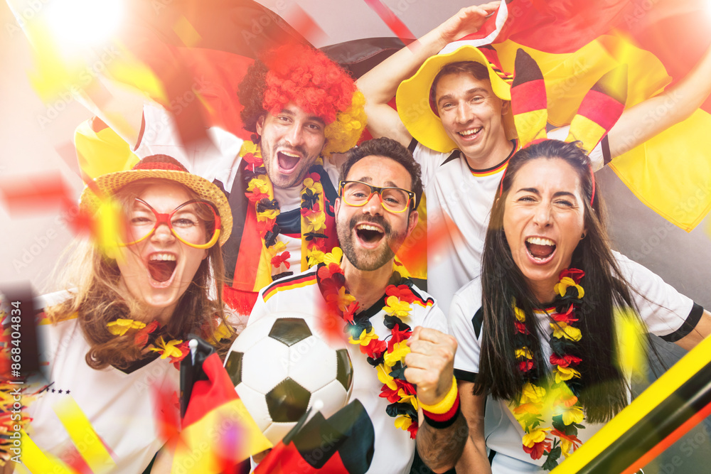 Fototapeta premium Group of enthusiastic German soccer fans celebrating the victory