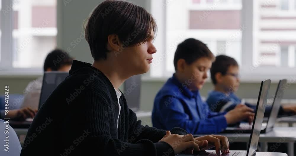 Pupils In Computer-Based Classroom Of High School, Teens Schoolboys Working With Laptops Pupils In Computer-Based Classroom Of High School, Teens Schoolboys Working With Laptops