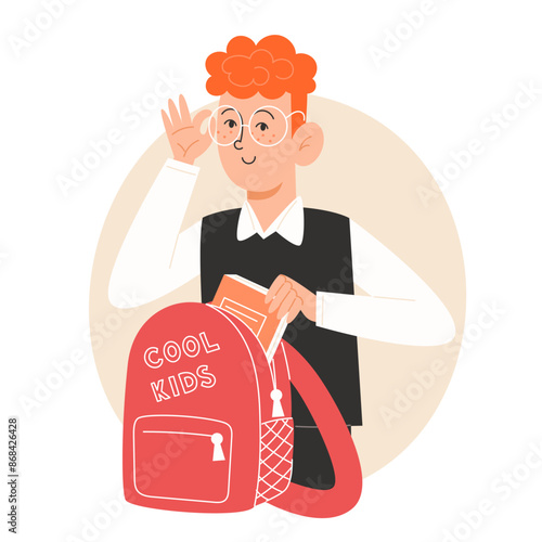 A schoolboy in a school uniform packs a backpack to school