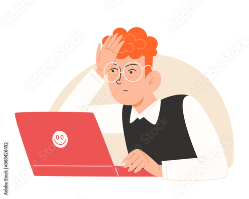 Confused schoolboy in school uniform looking at laptop
