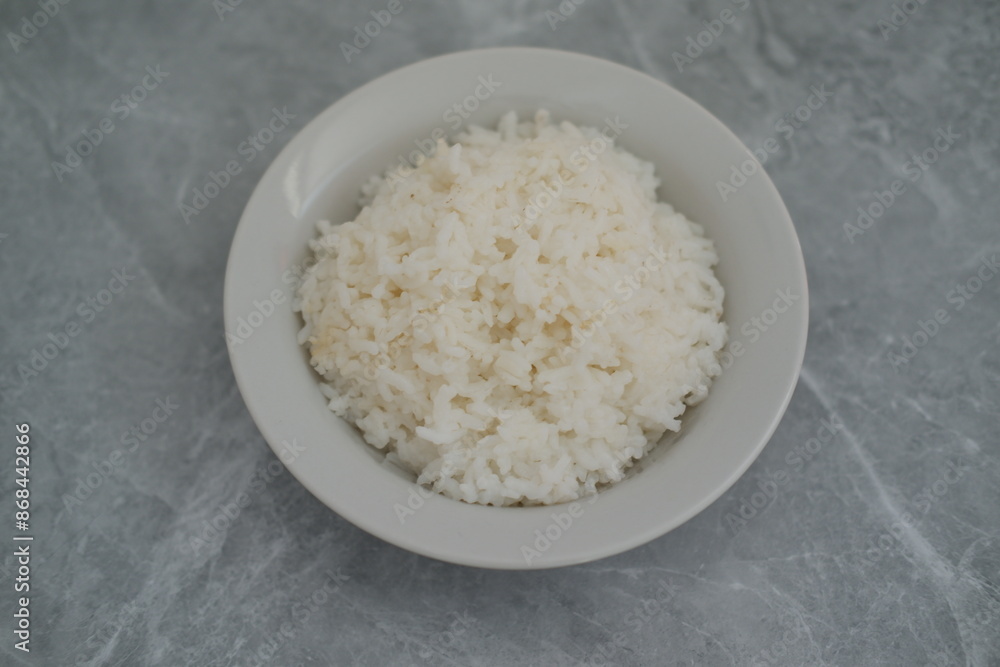 Cooked rice in a bowl background, top view. Cooked rice in a bowl background, top view.