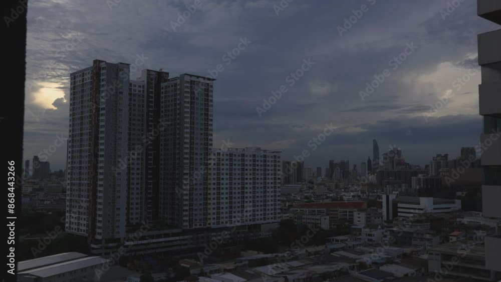High-angle 4K video that sees condominiums of various sizes encircling the city center, business district, and blurry lights and passing cars during the evening twilight sky. High-angle 4K video that sees condominiums of various sizes encircling the city center, business district, and blurry lights and passing cars during the evening twilight sky.