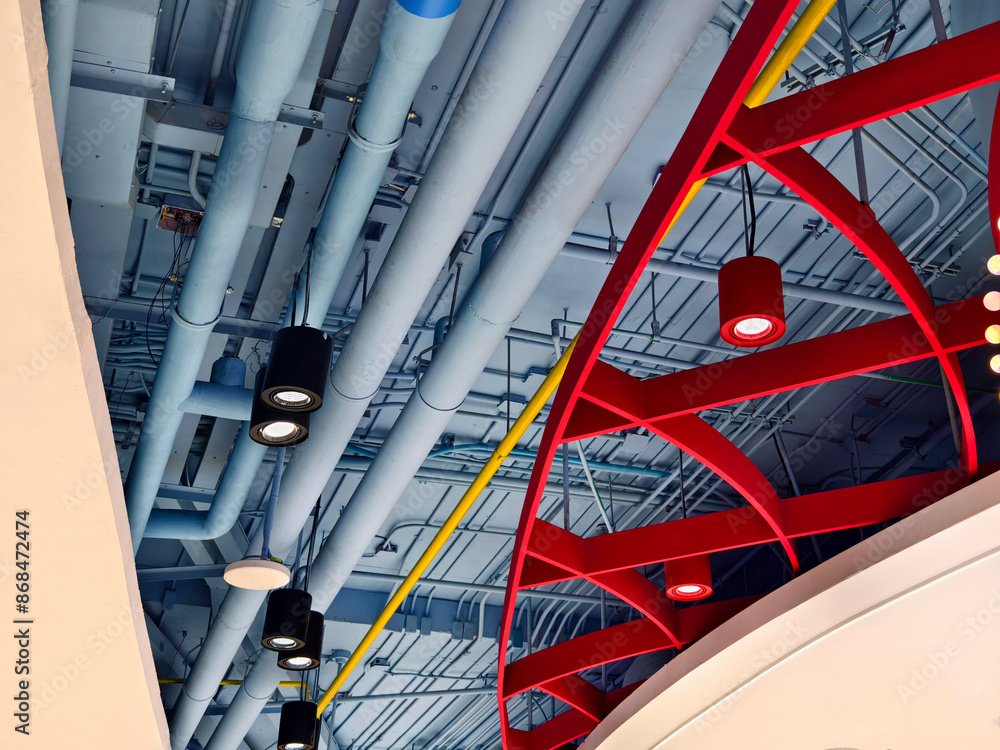 Ceiling with pipes and lights in creates industrial a pattern Ceiling with pipes and lights in creates industrial a pattern