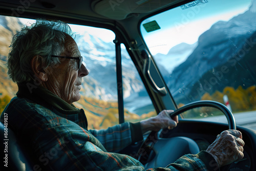 Elderly Man Driving Through Mountains