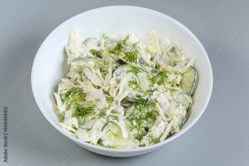 Green salad of sliced fresh vegetables with mayonnaise dressing