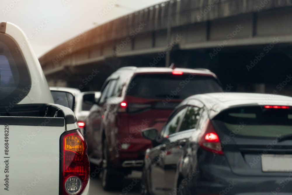 Rear side view of pickup car white color. Traffic jam on the road with cars in the city. Blurred background of concrete bridge. under white sky. Rear side view of pickup car white color. Traffic jam on the road with cars in the city. Blurred background of concrete bridge. under white sky.