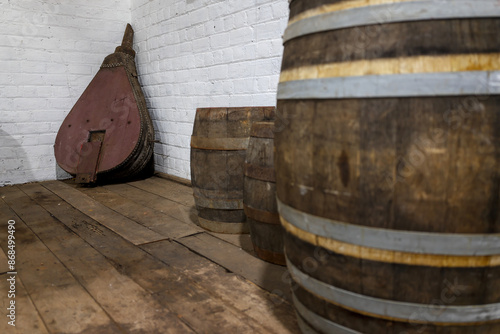 Old fire bellows and wine barrels, casks in historic farm building with hardwood floors, near town of Toodyay, Wheatbelt region, Western Australia photo