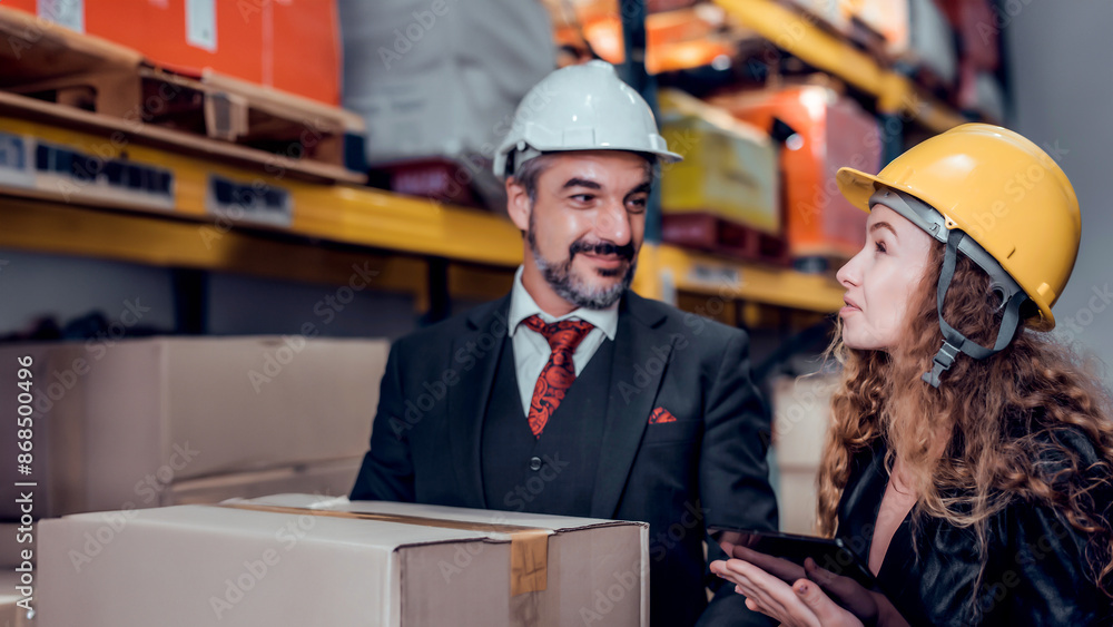 Engineer woman and businessman wearing a hardhat standing cargo at goods warehouse and check for control loading from Cargo freight ship for import and export by report on laptop. Teamwork concept
Engineer woman and businessman wearing a hardhat standing cargo at goods warehouse and check for control loading from Cargo freight ship for import and export by report on laptop. Teamwork concept
