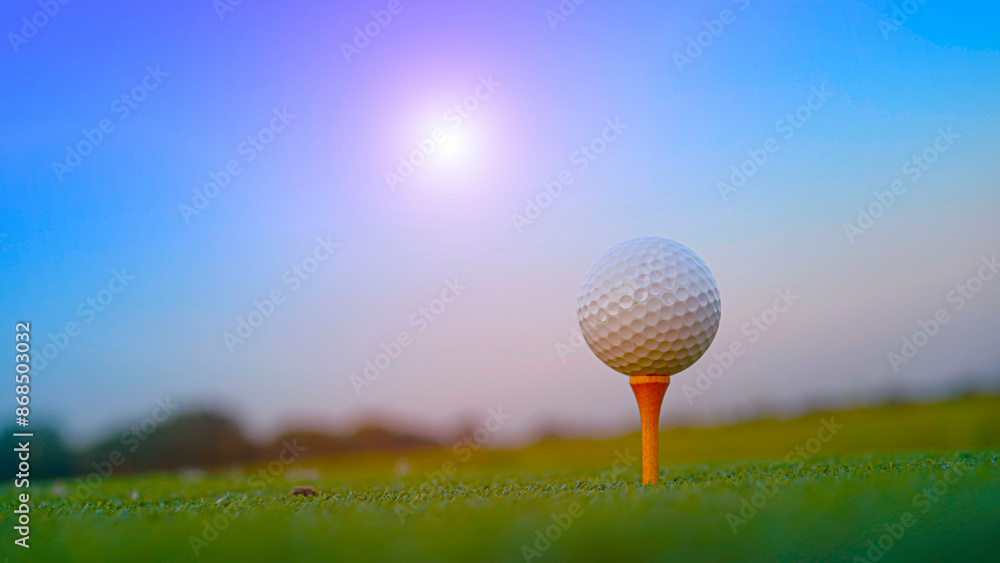 Golf ball on tee in a beautiful golf course with morning sunshine. Golf ball on tee in a beautiful golf course with morning sunshine.