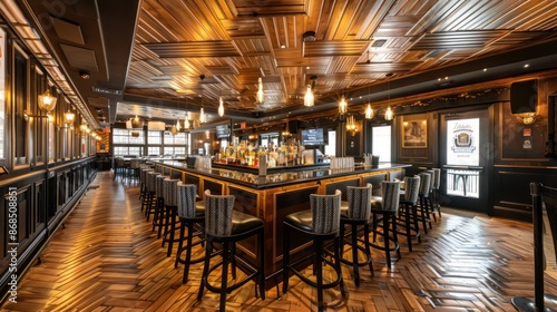 upscale bar with a ceiling of herringbone-patterned wood panels, providing a classic yet contemporary look © Ramzan