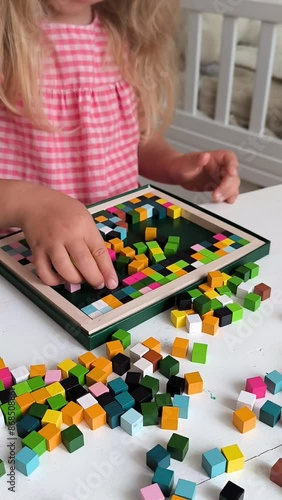 little girl play wooden blocks constructor, wooden mosaic