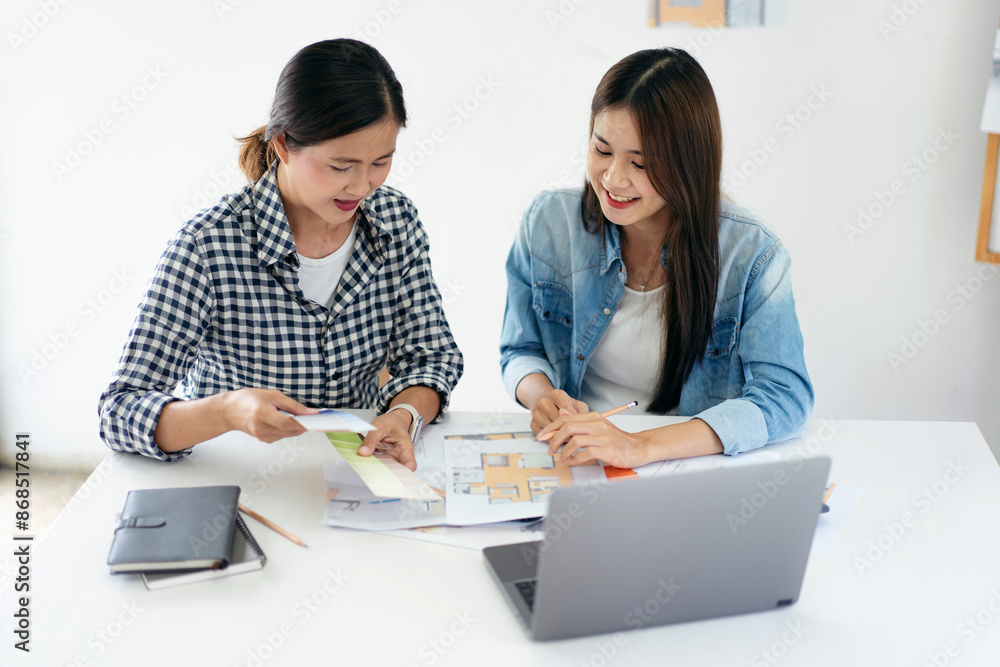 Architect team holding color swatch and blueprint to brainstorming together about designing and sketching Architect team holding color swatch and blueprint to brainstorming together about designing and sketching