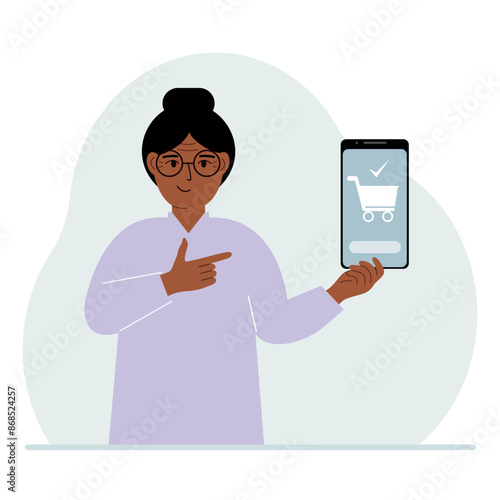 A woman holds a mobile phone in his hand with an application for online shopping. The phone has a shopping cart.