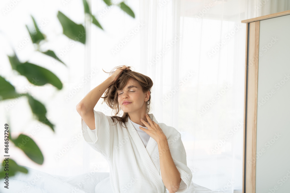 woman checks her hair health after waking up in the morning. woman checks her hair health after waking up in the morning.