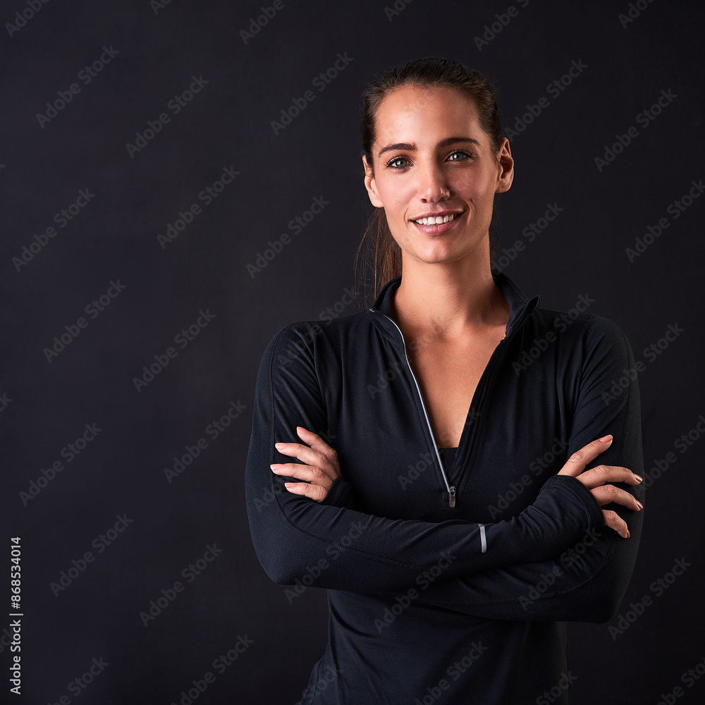 Woman, smile and crossed arms in studio for fitness, health and workout on black background. Female athlete, portrait and confident for face, wellness or performance training at sport competition Woman, smile and crossed arms in studio for fitness, health and workout on black background. Female athlete, portrait and confident for face, wellness or performance training at sport competition