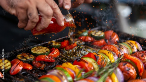 A chef seasoning grilled vegetables with crushed red garlic and olive oil, enhancing flavors for a healthy and delicious meal. photo