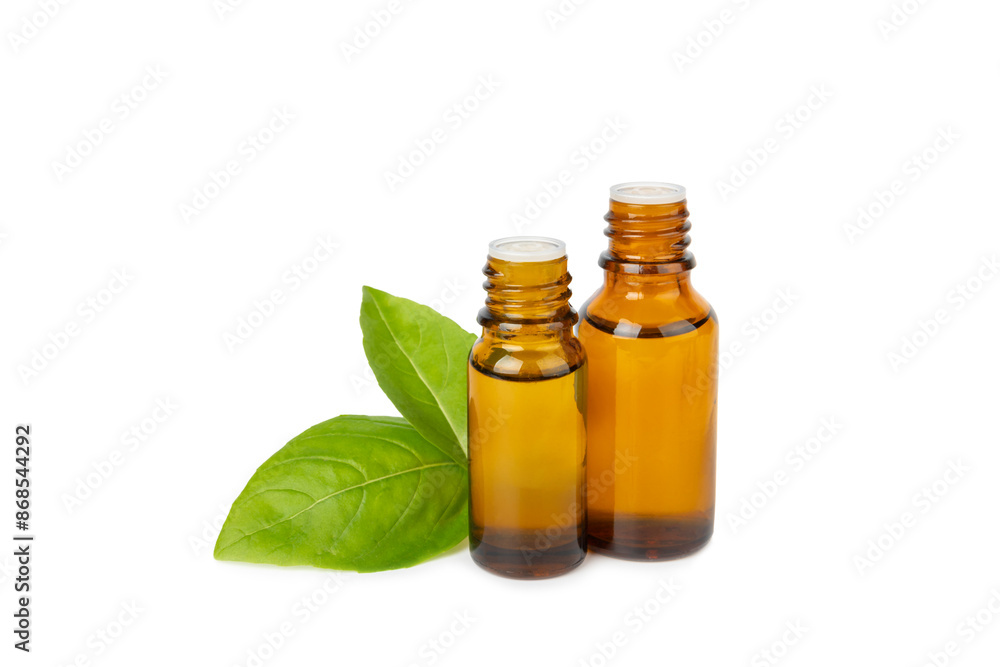 Basil essential oil isolated on white background. Basil essential oil and fresh leaves. Aromatherapy. Aroma oil. Medical herbs. Alternative medicine. Place for text. Copy space. Basil essential oil isolated on white background. Basil essential oil and fresh leaves. Aromatherapy. Aroma oil. Medical herbs. Alternative medicine. Place for text. Copy space.
