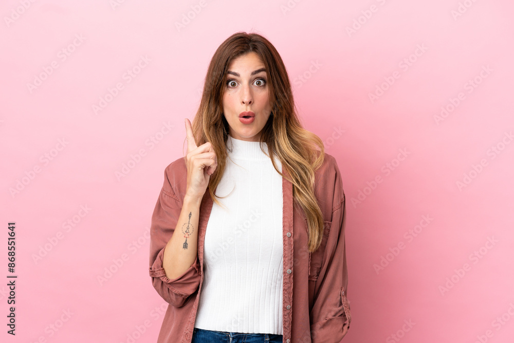 Caucasian woman isolated on pink background intending to realizes the solution while lifting a finger up Caucasian woman isolated on pink background intending to realizes the solution while lifting a finger up