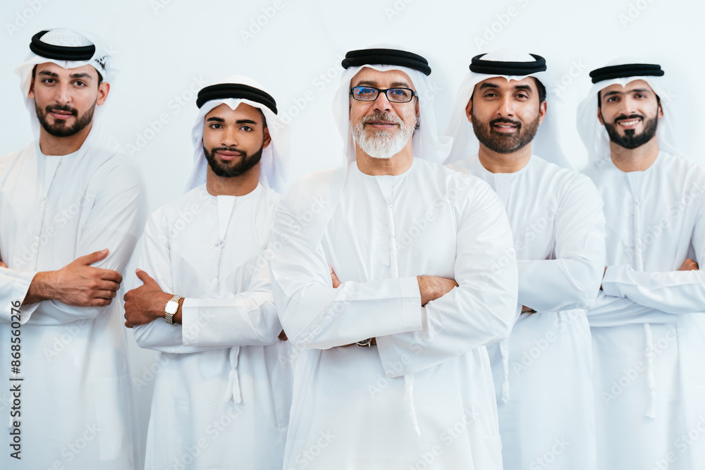 Group of corporate arab businessmen meeting in the office - Business people wearing traditional emirati kandura working together in Dubai Group of corporate arab businessmen meeting in the office - Business people wearing traditional emirati kandura working together in Dubai