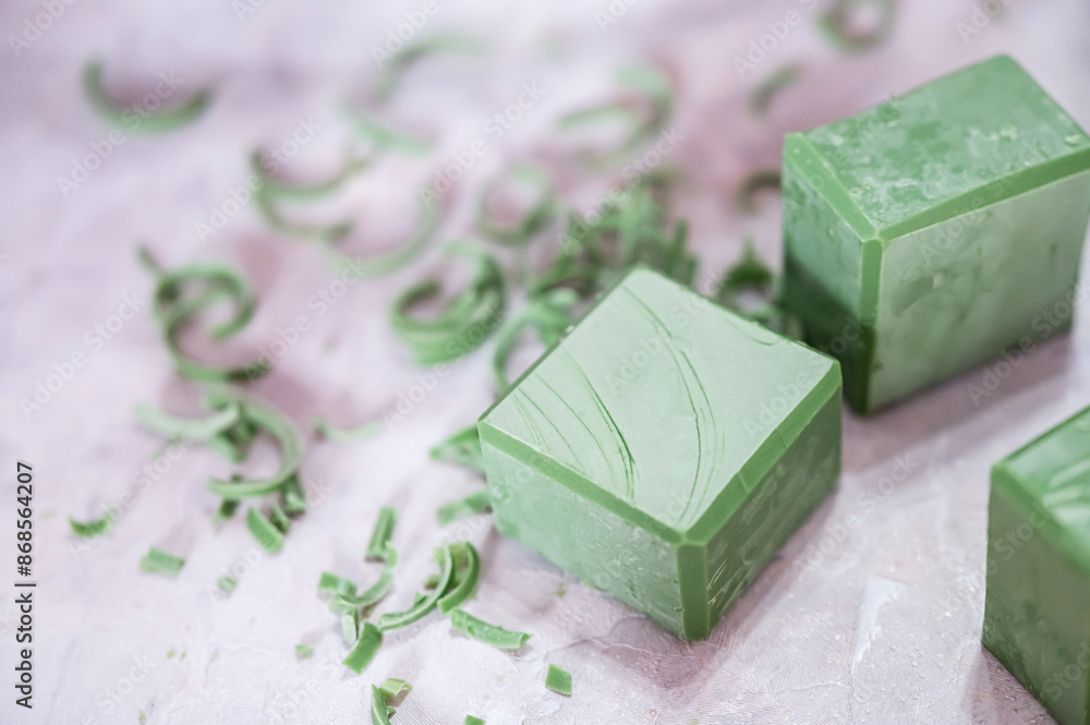 Olive oil soap and soap shavings on a white cloth background. Olive oil soap and soap shavings on a white cloth background.