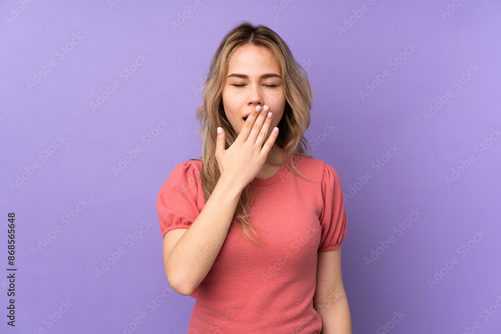 Teenager Russian girl isolated on purple background yawning Teenager Russian girl isolated on purple background yawning