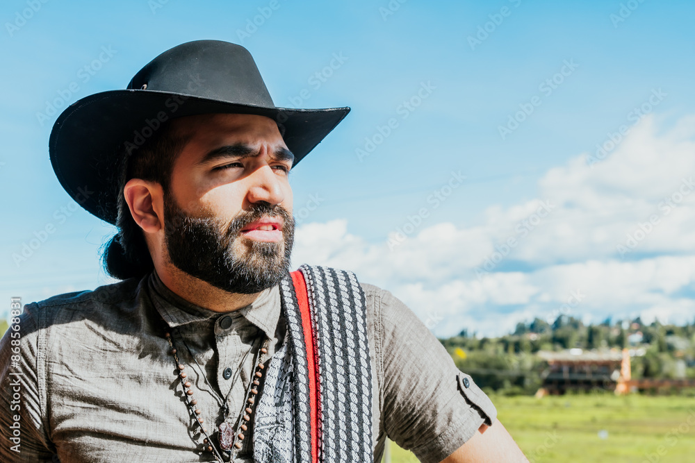 Obraz premium Latin man with cowboy hat enjoying his vacation in Colombia. Culture, travel and holidays.