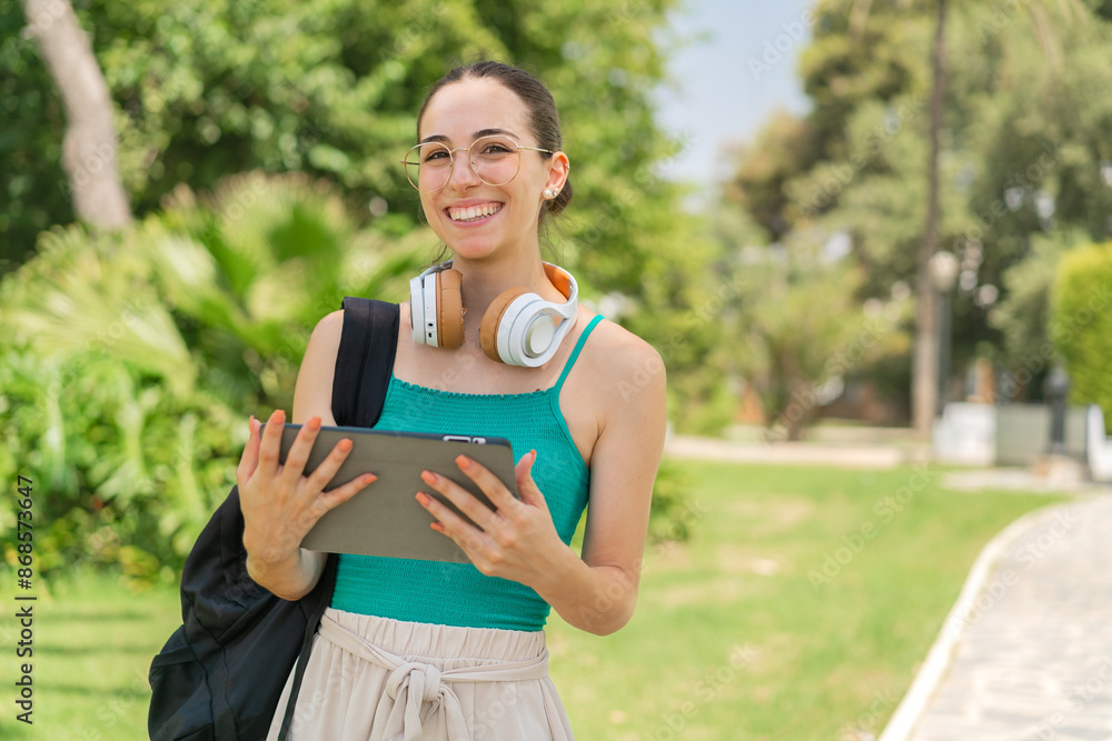 Young pretty woman at outdoors holding a tablet Young pretty woman at outdoors holding a tablet
