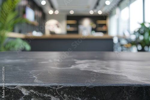 Black stone table top and blurred bokeh office interior space background - can used for display or montage your products. Generative ai © FDStock