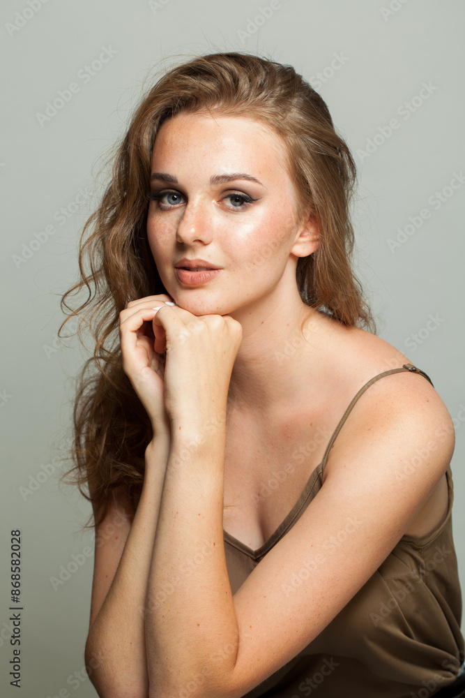 Naklejka premium Attractive smiling young adult woman studio photo
