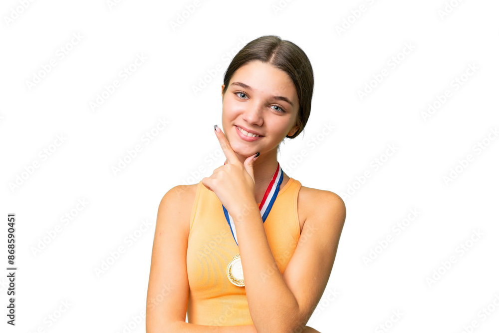 Teenager caucasian girl with medals over isolated background smiling