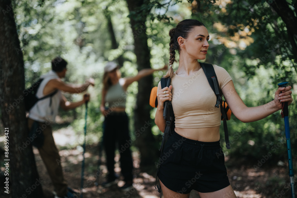 Group of friends hiking in a lush forest, embracing the outdoors and enjoying the adventure together. Group of friends hiking in a lush forest, embracing the outdoors and enjoying the adventure together.