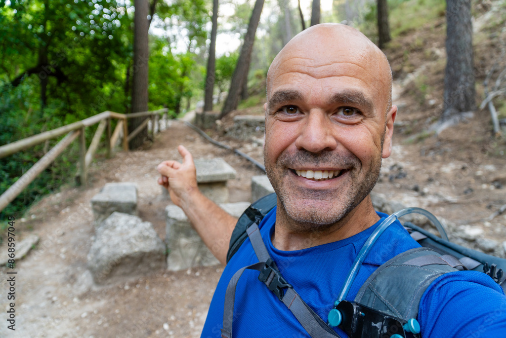 Male hiker takes a selfie outdoors at sunset Male hiker takes a selfie outdoors at sunset