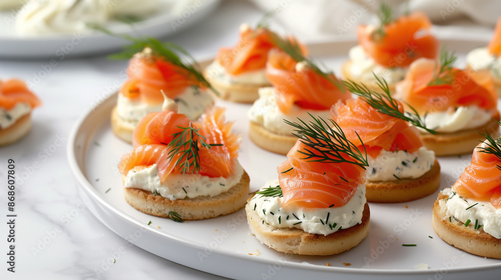 a platter of smoked salmon canapés, topped with cream cheese and dill, served on a slate board a platter of smoked salmon canapés, topped with cream cheese and dill, served on a slate board
